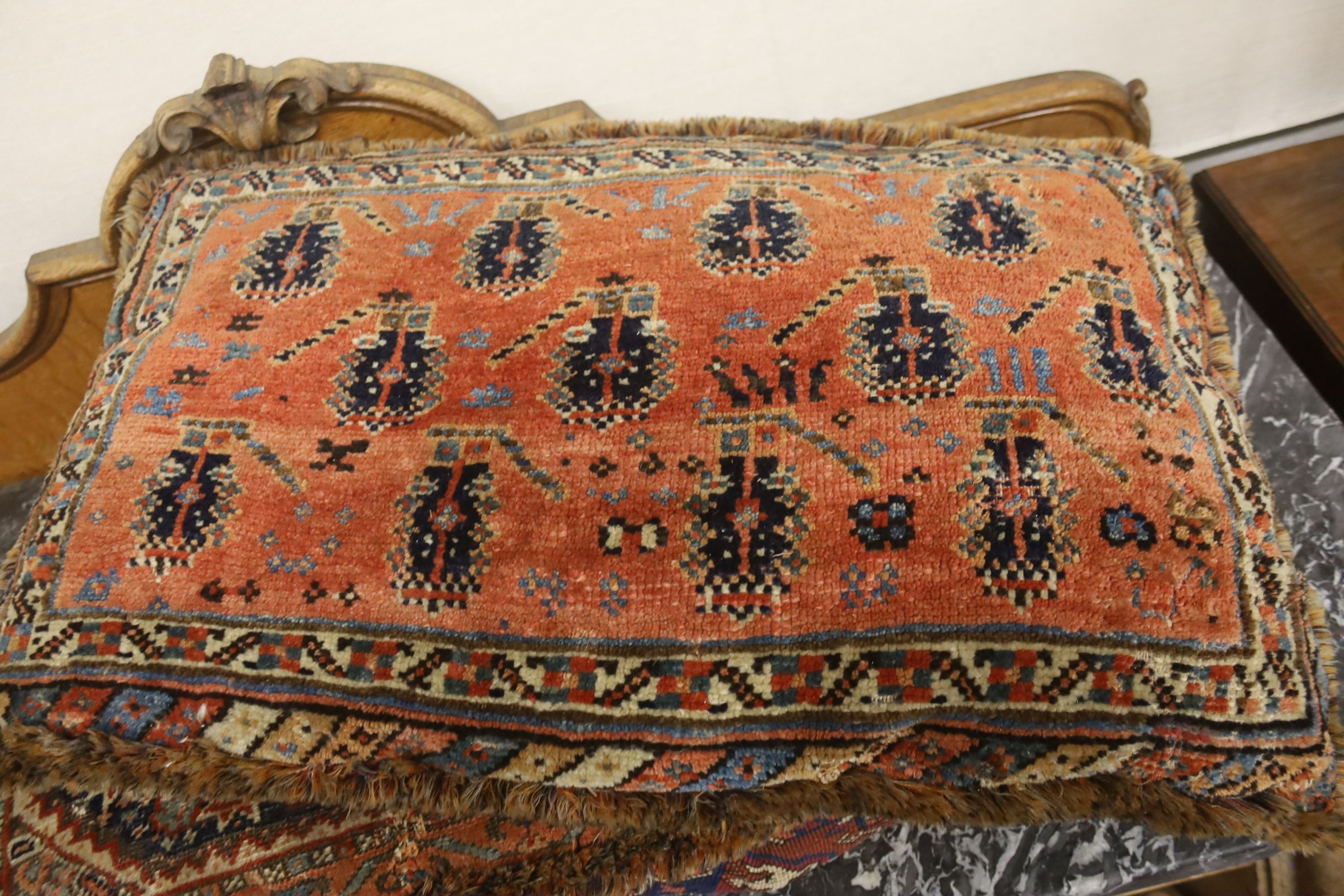 Three Bokhara rugs, four kilim-faced cushions and a small saddlebag, largest 74 x 50cm